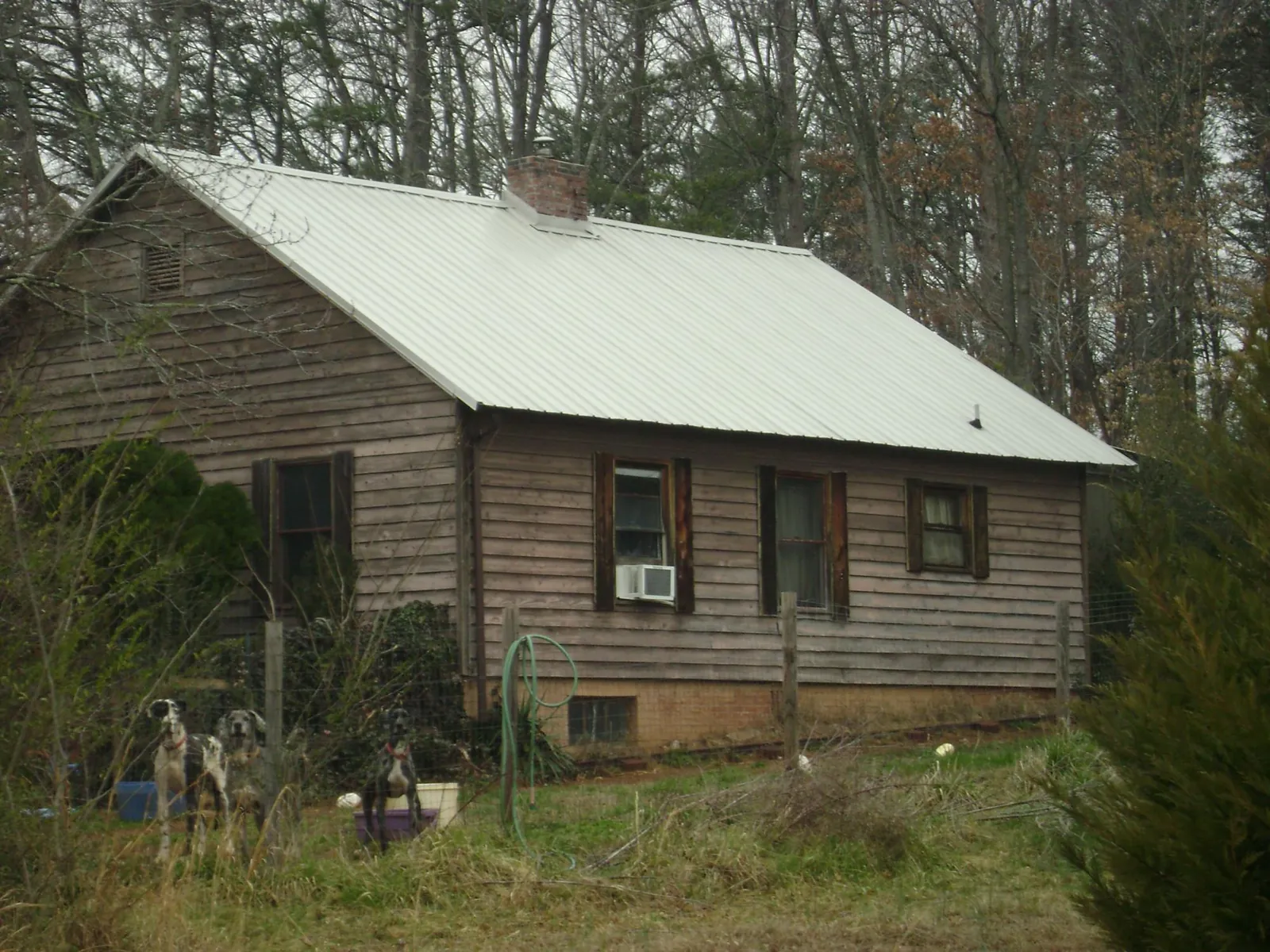 White metal roof on an old wood sided farmhouse in Salem